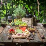 Garden table with cheese and wine Garden summer evening.