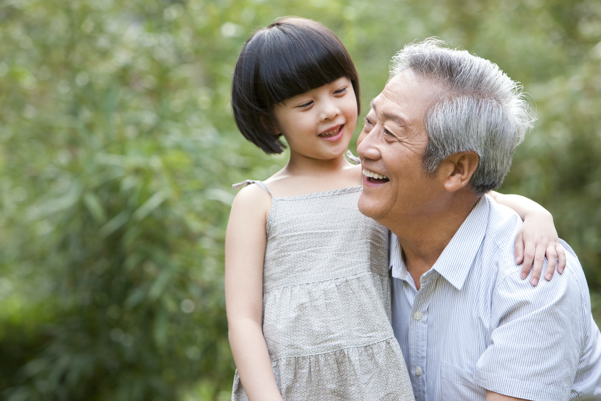 Grandpa and grandaughter having fun in garden